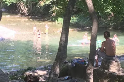 a group of people swimming in a river at Le gîte de la vallée du Douctouyre in Dun