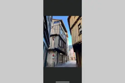 a picture of a street with an old building at Le gîte de la vallée du Douctouyre in Dun