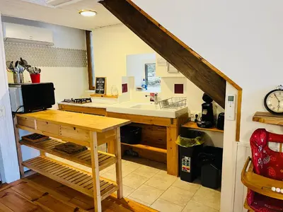 a kitchen with a sink and a counter top at Le gîte de la vallée du Douctouyre in Dun
