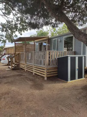 a mobile home with a porch and a deck at Mobilhome climatisé et ombragé in Port-la-Nouvelle