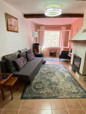 a living room with a couch and a fireplace at La Maisonnette D'Agel in Agel
