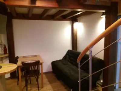 a living room with a couch and a table at Studio la Nuit au Coeur de ville in Limoux