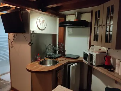 a small kitchen with a sink and a microwave at Studio la Nuit au Coeur de ville in Limoux