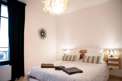 a bedroom with a bed with two towels on it at 101 Cour de la Bastide in Carcassonne