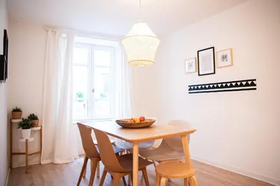 a dining room table with chairs and a bowl of fruit on it at 101 Cour de la Bastide in Carcassonne