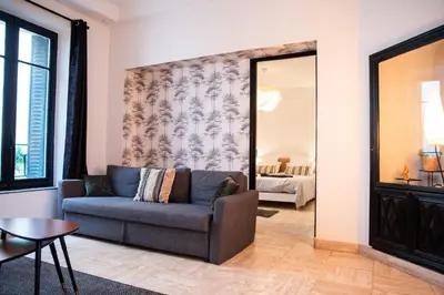 a living room with a couch and a mirror at 101 Cour de la Bastide in Carcassonne