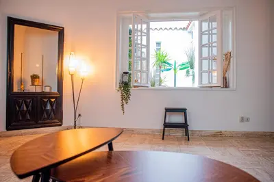 a living room with a table and a window at 101 Cour de la Bastide in Carcassonne