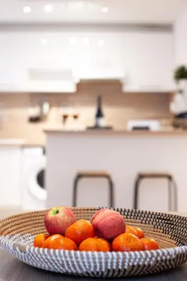 a plate of fruit on a table in a kitchen at 101 Cour de la Bastide in Carcassonne