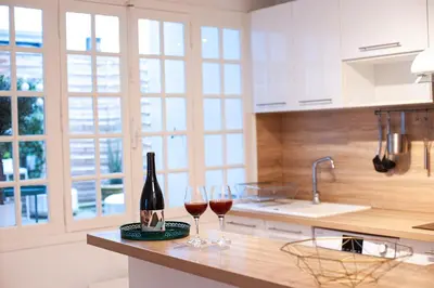 two glasses of wine on a counter in a kitchen at 101 Cour de la Bastide in Carcassonne