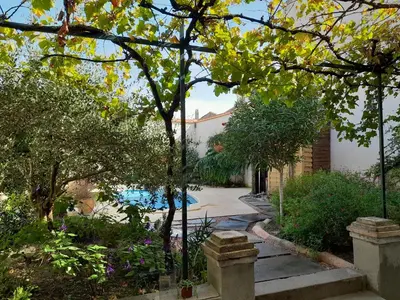 a house with a swimming pool in a garden at Villa Saint Léon in Badens