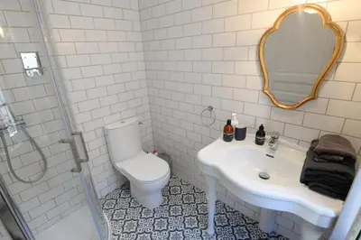a bathroom with a toilet and a sink and a shower at La Maison de L' Ambassadeur Carcassonne B&B in Carcassonne