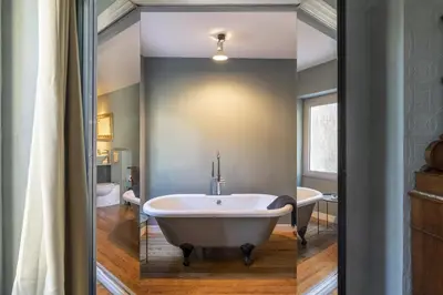 a bathroom with a bath tub and a sink at La Maison de L' Ambassadeur Carcassonne B&B in Carcassonne