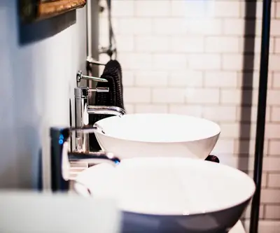 a bathroom with two toilets and a sink at La Maison de L' Ambassadeur Carcassonne B&B in Carcassonne
