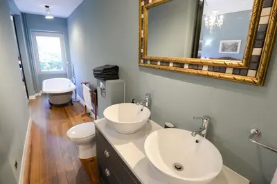 a bathroom with a sink and a mirror and a toilet at La Maison de L' Ambassadeur Carcassonne B&B in Carcassonne