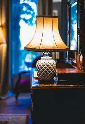a lamp sitting on top of a table at La Maison de L' Ambassadeur Carcassonne B&B in Carcassonne