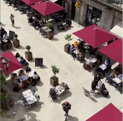 an overhead view of a restaurant with people sitting at tables at La Maison de L' Ambassadeur Carcassonne B&B in Carcassonne