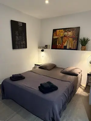 a bedroom with a bed with two pillows on it at L'atelier in Capestang