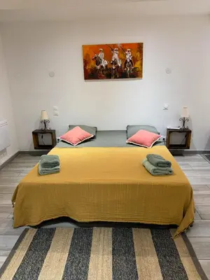 a bedroom with a large bed with a yellow blanket at L'atelier in Capestang