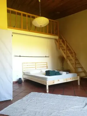 a bed in a room with wooden walls at Charmant Mas tout équipé en pleine nature catalane in Cases-de-Pène
