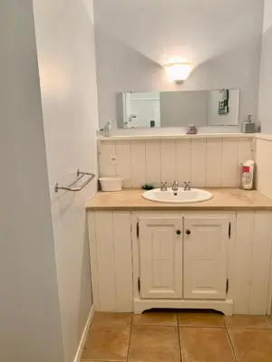 a bathroom with a sink and a mirror at Chez Noisette in Durban-Corbières