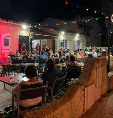 a crowd of people sitting at tables in a restaurant at Chez Noisette in Durban-Corbières
