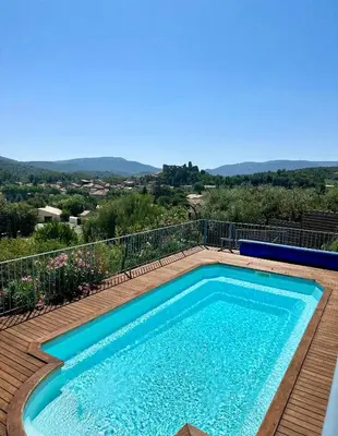 a swimming pool on the deck of a house at Chez Noisette in Durban-Corbières