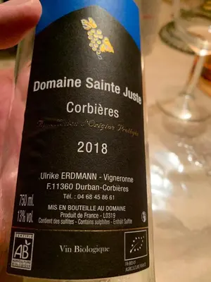 a bottle of wine sitting on top of a table at Chez Noisette in Durban-Corbières