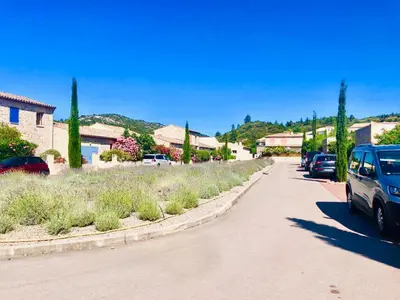a street with cars parked on the side of a road at Chez Noisette in Durban-Corbières