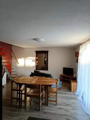 a living room with a table and a couch at La Sigeannaise maison climatisée Wi-Fi in Sigean