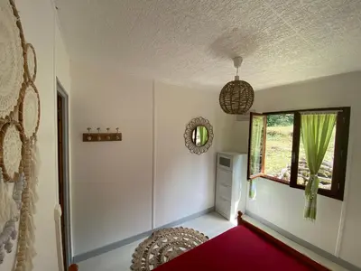 a room with a bed and a window at RIBES - Chalet Gîte au coeur de la nature in Sournia