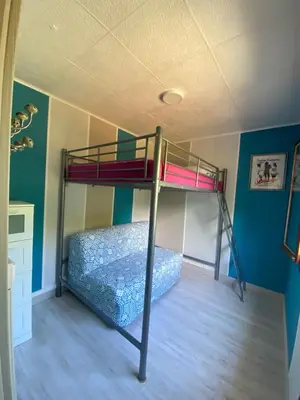 a bedroom with a bunk bed in a room at RIBES - Chalet Gîte au coeur de la nature in Sournia