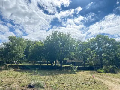 a field with trees and a sky with clouds at RIBES - Chalet Gîte au coeur de la nature in Sournia