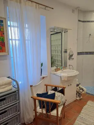 a bathroom with a sink and a mirror at Le gîte de Sainte Valière PISCINE,SPA et CLIMATISATION in Sainte-Vallière