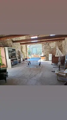 a bedroom with a bed and a chair and two lamps at Le gîte de Sainte Valière PISCINE,SPA et CLIMATISATION in Sainte-Vallière