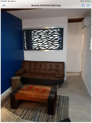 a living room with a brown couch and a coffee table at Appartement Plein centre in Narbonne