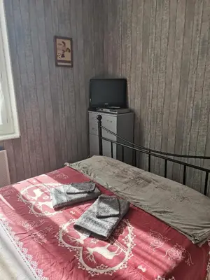 a bedroom with a bed with two towels on it at Chambres d'hôtes Natacha et Franck in Labastide-Rouairoux