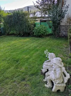 a group of statues sitting on a bench in a yard at Chambres d'hôtes Natacha et Franck in Labastide-Rouairoux