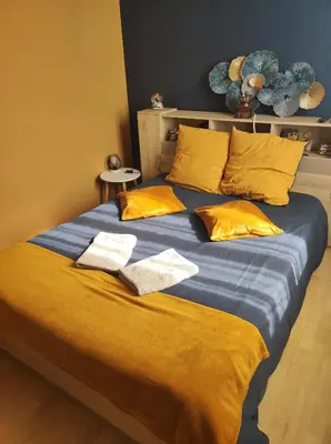 a large bed with two towels on top of it at Chambres d'hôtes Natacha et Franck in Labastide-Rouairoux