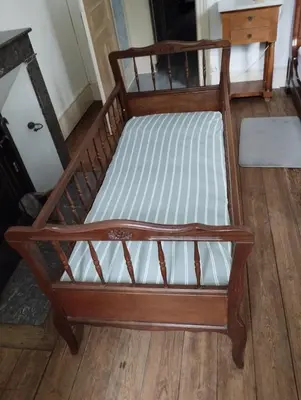 a wooden bed with white sheets on a wooden floor at MAISON ALBA LA SOURCE in Mazamet