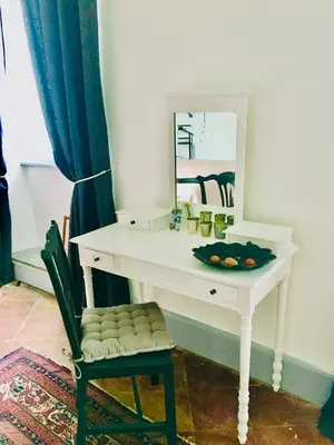 a white desk with a mirror and a chair at Le Domaine de Villespy in Villespy