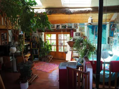 a room filled with lots of potted plants at Chambre d'hôtes Le Rougeyras in Roquebrun