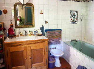 a bathroom with a sink and a tub and a toilet at Chambre d'hôtes Le Rougeyras in Roquebrun