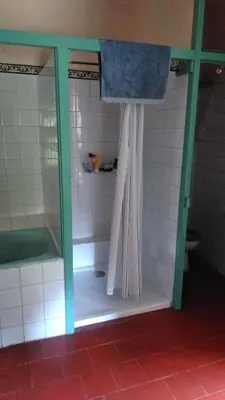 a bathroom with a shower and a tub and a toilet at Chambre d'hôtes Le Rougeyras in Roquebrun