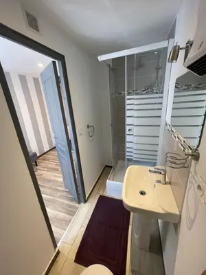 a bathroom with a sink and a walk in shower at La pause du canal in Trèbes