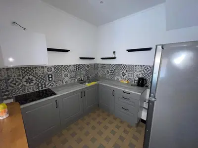 a kitchen with a sink and a refrigerator at La pause du canal in Trèbes