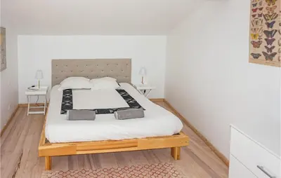 a bedroom with a bed with white sheets and pillows at Lovely Home In Siran With Wifi in Siran