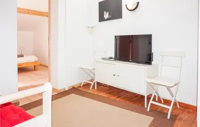 a living room with a tv on a dresser at Lovely Home In Siran With Wifi in Siran