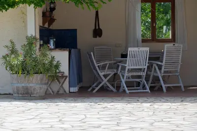 a garden with purple flowers next to a swimming pool at Le Bariole, luxury villa with heated pool in Cesseras