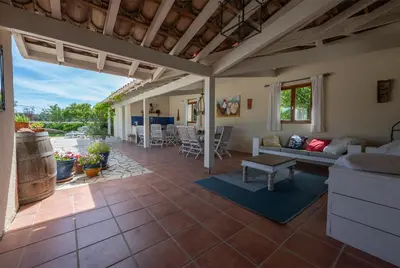 a pair of chairs sitting on a patio at Le Bariole, luxury villa with heated pool in Cesseras