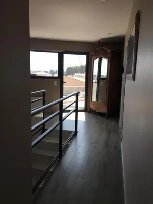 a hallway with stairs and a door to a room at Blue Diamond Room in Salles-dʼAude